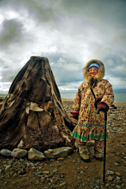 An Inuit Elder provides interpretation beside a traditional tent near Gjoa Haven.