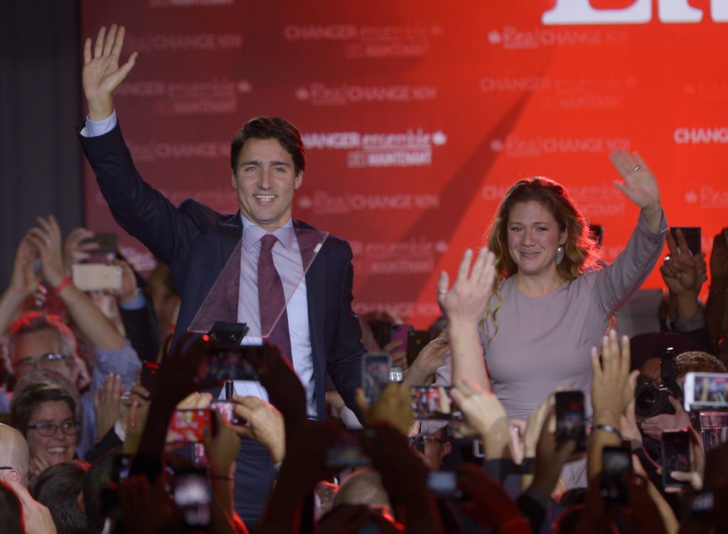 Liberal leader and incoming prime minister Justin Trudeau makes his way to the stage with wife Sophie Gregoire at Liberal party headquarters in Montreal early Tuesday, Oct. 20, 2015. THE CANADIAN PRESS/Paul Chiasson