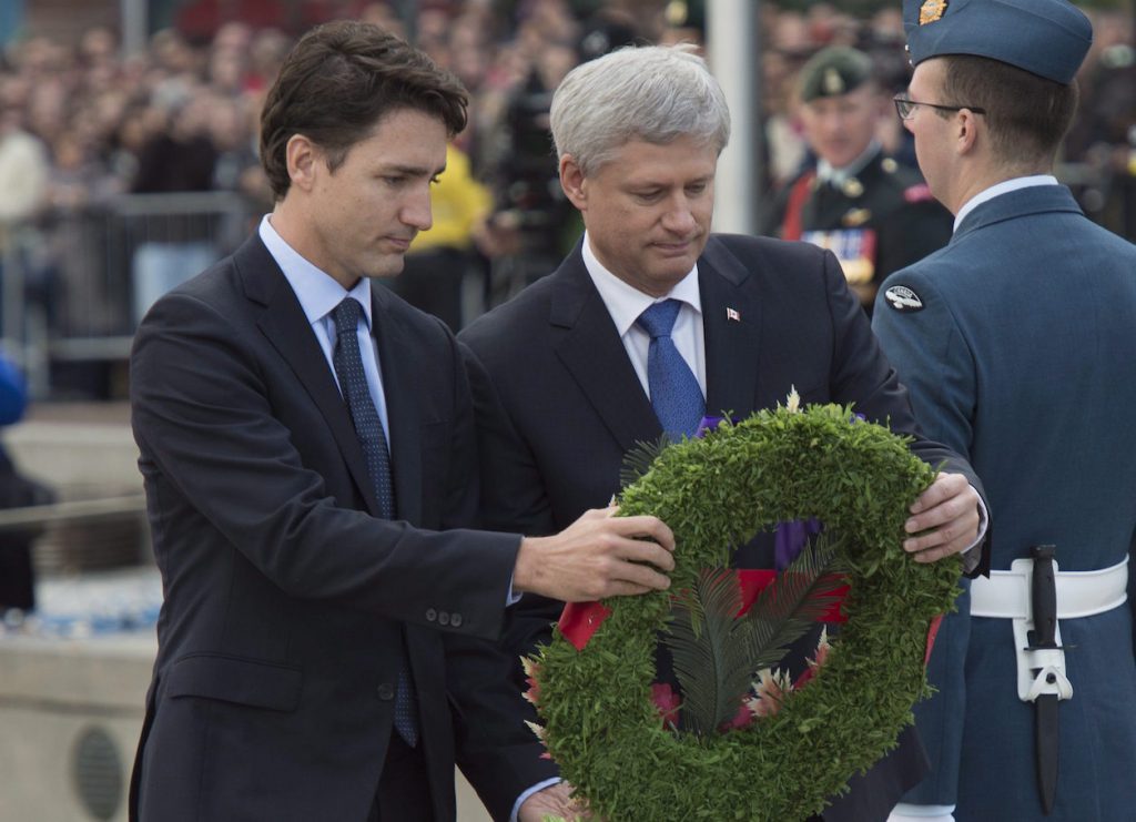 Prime Minister Stephen Harper and prime minister-designate Justin Trudeau lay a wreath during a ceremony marking the one year anniversary of the attack on Parliament Hill Thursday Oct. 22, 2015 at the National War Memorial in Ottawa. THE CANADIAN PRESS/Adrian Wyld