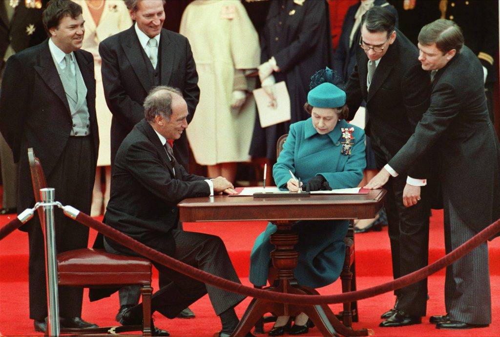 Queen Elizabeth II signs Canada's constitutional proclamation in Ottawa on April 17, 1982 as Prime Minister Pierre Trudeau looks on. The Harper government says it will mark the 30th anniversary of the patriation of the Constitution  by issuing a couple of news releases.THE CANADIAN PRESS/Stf-Ron Poling