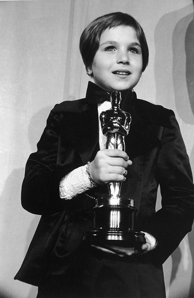 2nd April 1974: American actor Tatum O'Neal, wearing a tuxedo, holds her Oscar for Best Supporting Actress for her role in director Peter Bogdanovich's film, 'Paper Moon,' at the 46th Annual Academy Awards, Dorothy Chandler Pavilion, Los Angeles, California. She was the youngest actor to ever win an Oscar. (Photo by Hulton Archive/Getty Images)