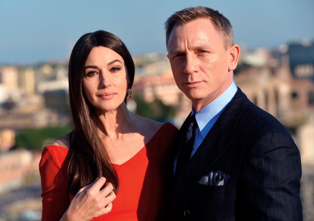 Italian actress Monica Bellucci and British actor Daniel Craig pose during a photocall to promote the 24th James Bond film 'Spectre' on February 18, 2015 at Rome's city hall. AFP PHOTO / TIZIANA FABI (Photo credit should read TIZIANA FABI/AFP/Getty Images)