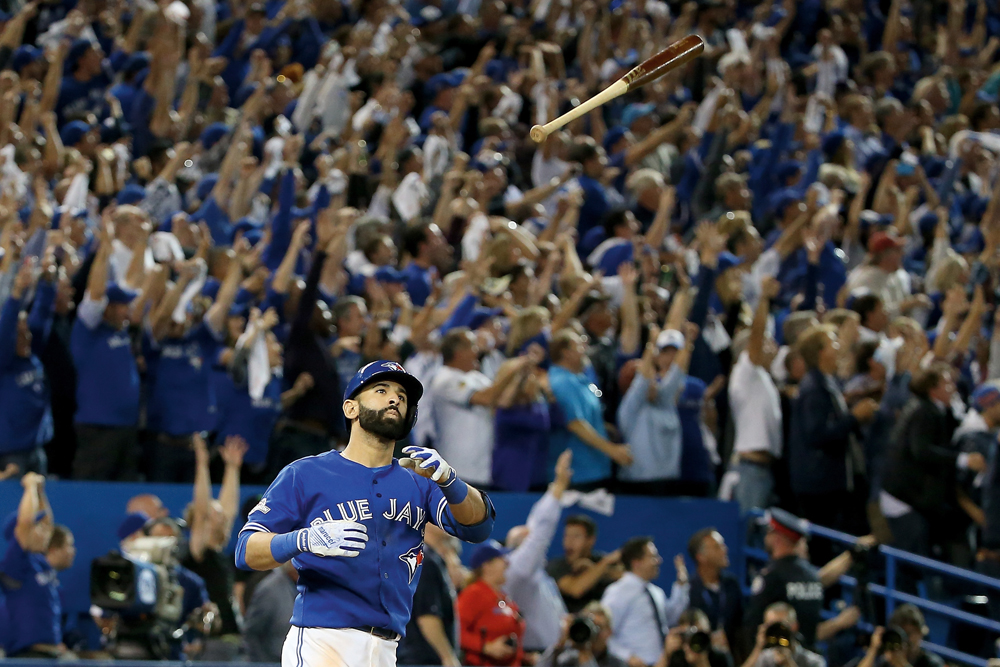 TORONTO, ON - OCTOBER 14: Jose Bautista #19 of the Toronto Blue Jays flips his bat up in the air after he hits a three-run home run in the seventh inning against the Texas Rangers in game five of the American League Division Series at Rogers Centre on October 14, 2015 in Toronto, Canada. (Photo by Tom Szczerbowski/Getty Images)