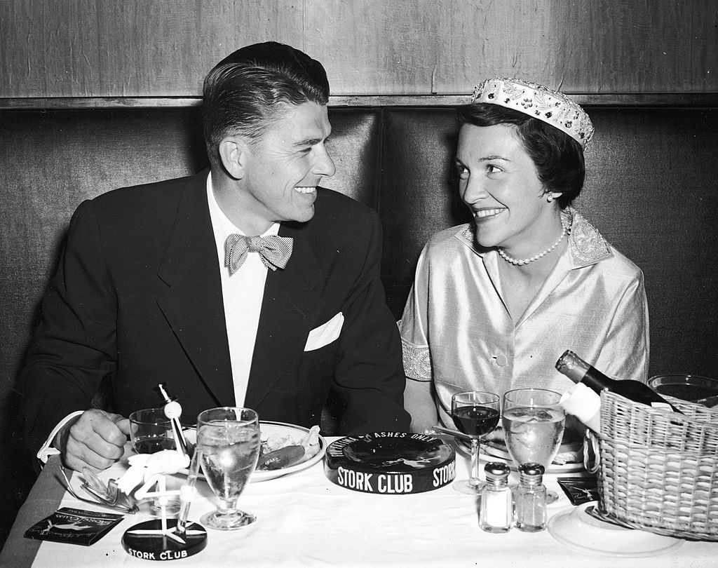 American actor Ronald Reagan and his wife Nancy Reagan smile as they have their honeymoon dinner at the Stork Club, New York City, 1952. (Photo by Hulton Archive/Getty Images)