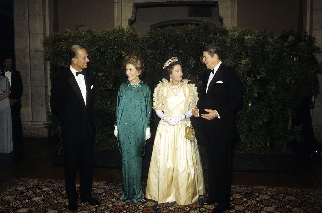 SAN FRANCISCO - MARCH 5: Queen Elizabeth ll, wearing a much critisized dress with bows and frills, Prince Philip, Duke of Edinburgh, President Ronald Reagan and his wife Nancy Reagan attend a banquet on March 5, 1983 in San Francisco, California. (Photo by Anwar Hussein/Getty Images)