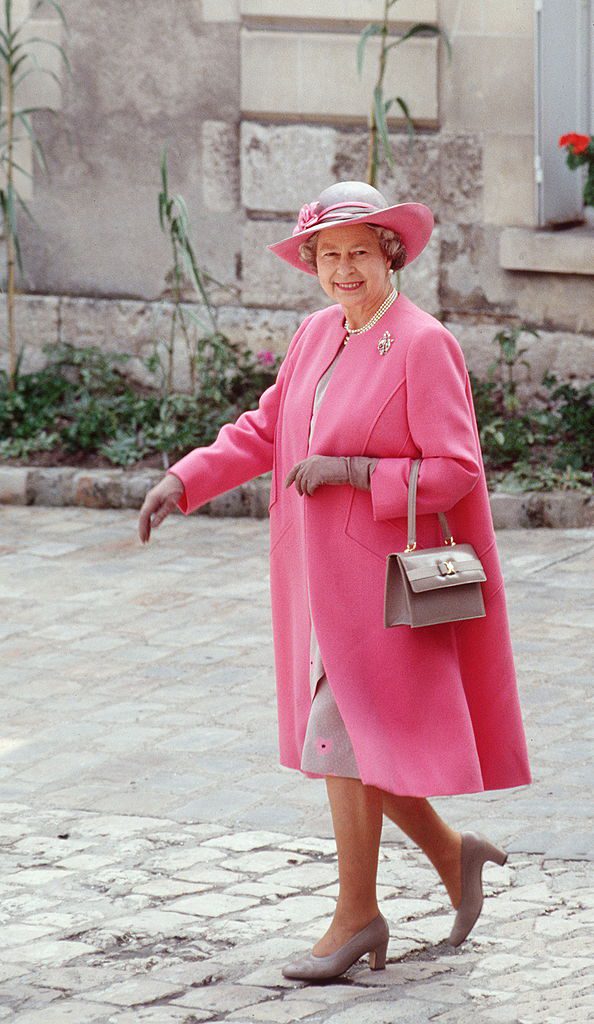 BLOIS, FRANCE - JUNE 11: The Queen On A Visit To Blois In France Wearing A Pink And Taupe Outfit Designed By Fashion Designer Ian Thomas With Colour Co-ordinated Taupe Shoes And Accessories (Photo by Tim Graham/Getty Images)