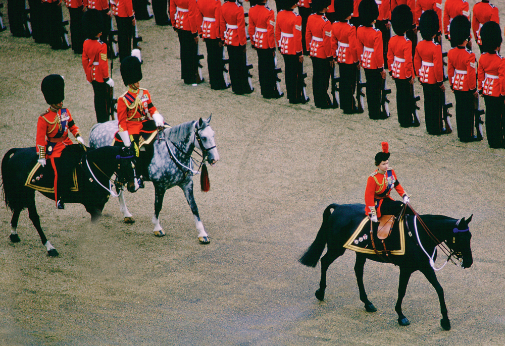 LONDON, UNITED KINGDOM - JUNE 03: Queen Elizabeth II On Horseguards Parade In London Riding Her Horse 'burmese' During The Traditional Queen's Birthday Parade At Trooping The Colour Ceremony. In Her Hat Is The Red Plume Of The Household Division The Coldstream Guards Whose Turn It Is To Have Their Colour Trooped. The Black Armbands Are Court Mourning After The Death Of The Duke Of Windsor. (Photo by Tim Graham/Getty Images)