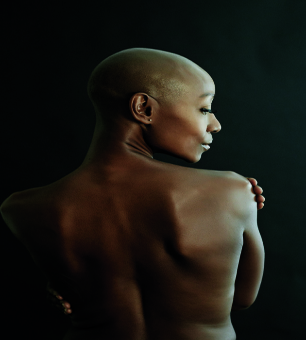 29 Oct 2014 --- Nude African American woman looking over her shoulder --- Image by � Blend Images/Corbis
