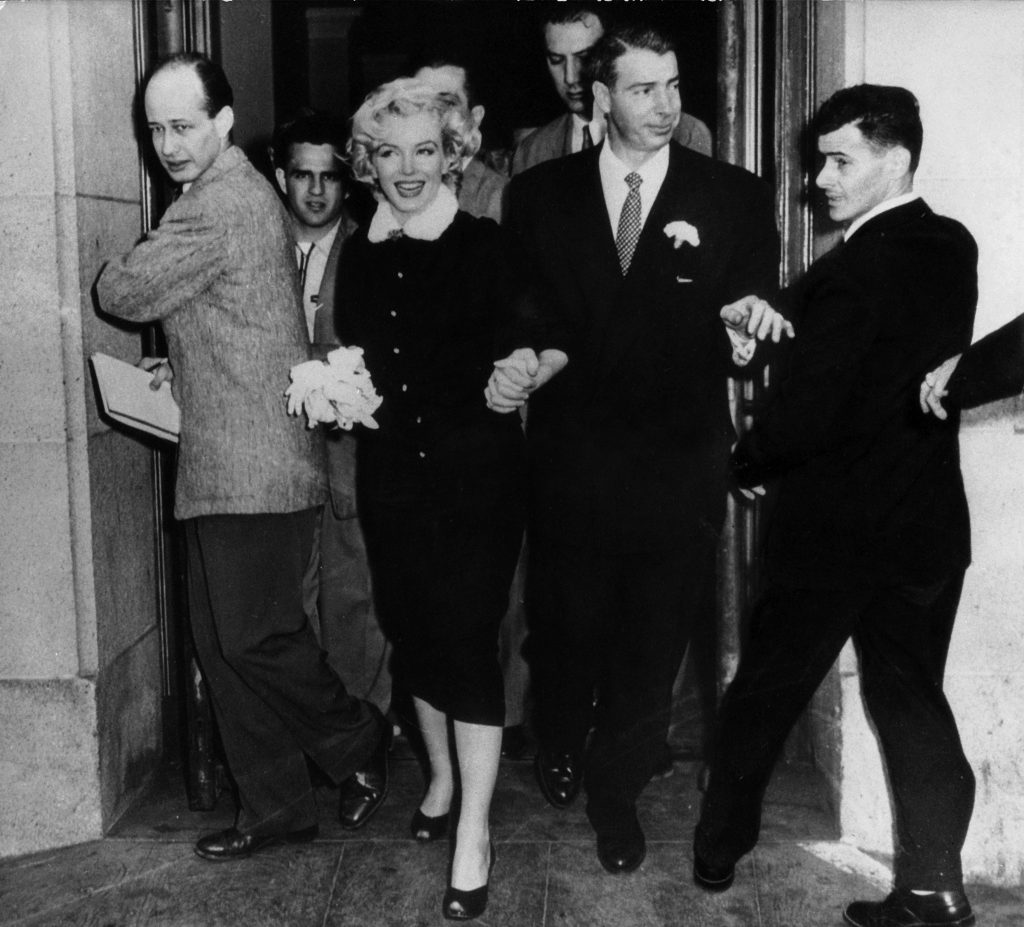The American actress Marilyn Monroe and her husband Joe DiMaggio leaving the town hall after their wedding. San Francisco, 14th January 1954 (Photo by Mondadori Portfolio via Getty Images)