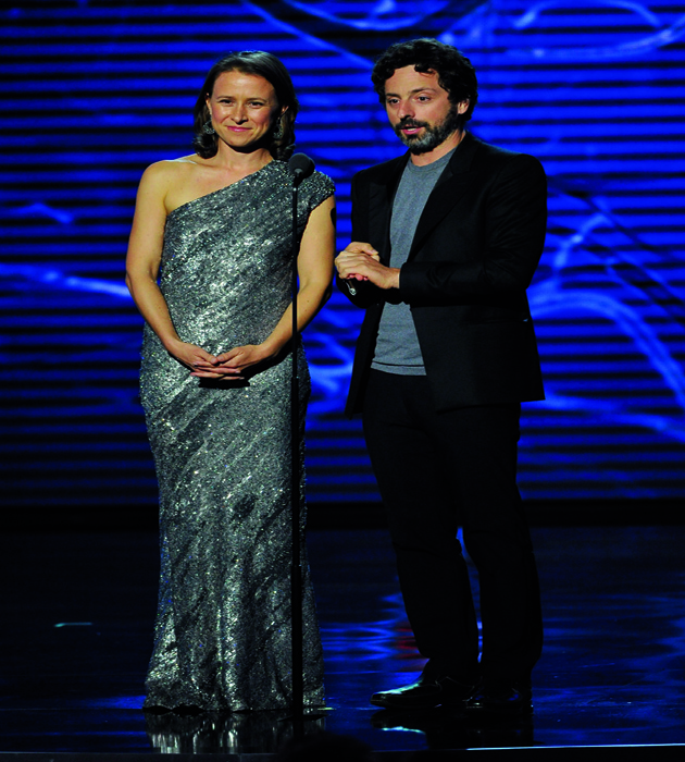 MOUNTAIN VIEW, CA - NOVEMBER 09: Breakthrough Prize Founders Anne Wojcicki (L) and Sergey Brin speak onstage during the Breakthrough Prize Awards Ceremony Hosted By Seth MacFarlane at NASA Ames Research Center on November 9, 2014 in Mountain View, California. (Photo by Steve Jennings/Getty Images for Breakthrough Prize)