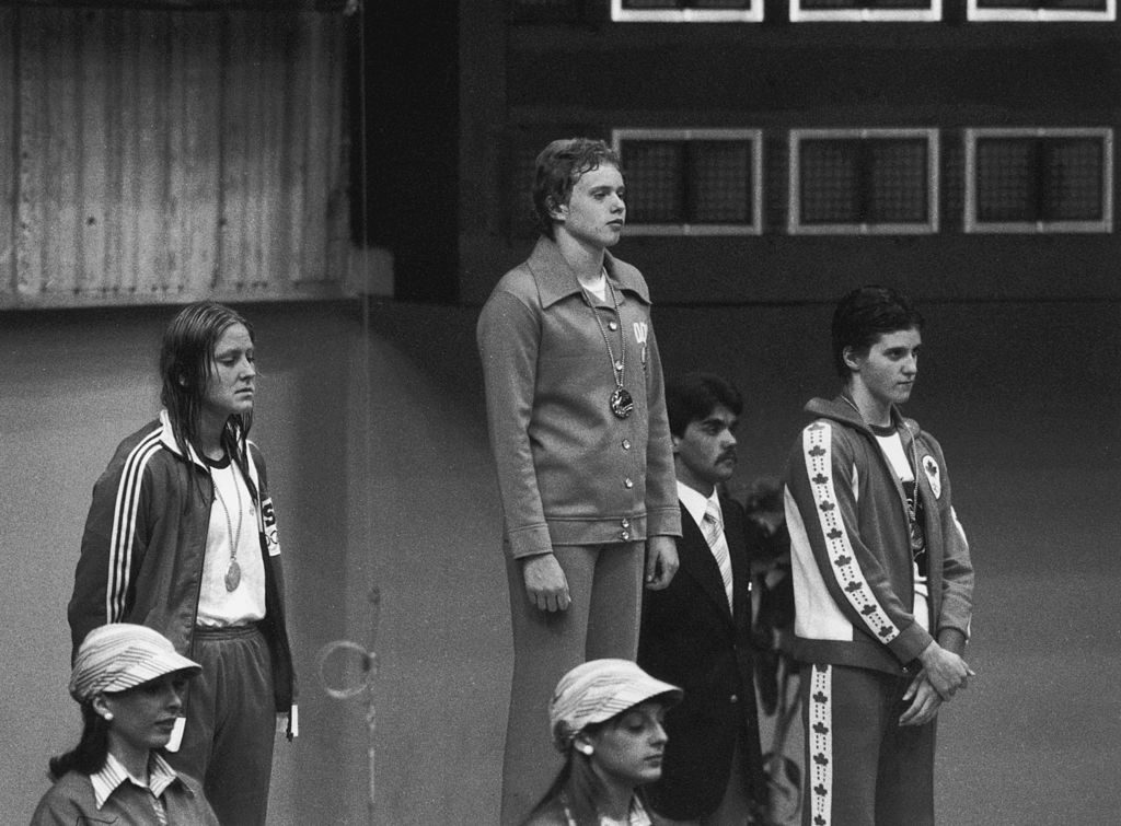 Swimmers recieve their medals after the women's 400 metres freestyle event at the Montreal Olympics, July 1976. Left to right: Shirley Babashoff of the U.S.A. (bronze), Petra Thumer of East Germany (gold) and Shannon Smith of Canada (silver). (Photo by Keystone/Hulton Archive/Getty Images)