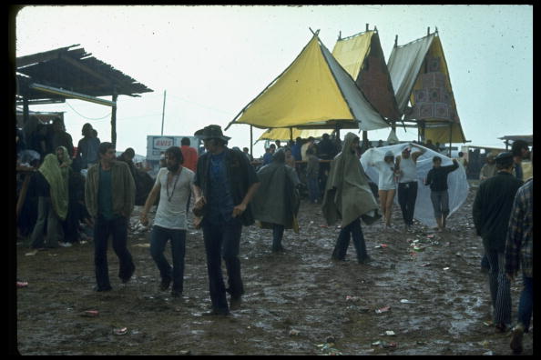 NEW YORK, UNITED STATES - AUGUST 1969: Overall of crowds of young people milling around big yellow tents during the Woodstock Music & Art Fair. (Photo by John Dominis/The LIFE Picture Collection/Getty Images)