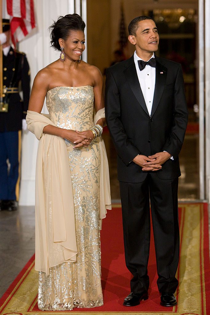 "U.S. President Barack Obama and first lady Michelle Obama await the arrival of India's Prime Minister Manmohan Singh and his wife Gursharan Kaur for a state dinner on the North Portico of the White House. " (Photo by Brooks Kraft LLC/Corbis via Getty Images)