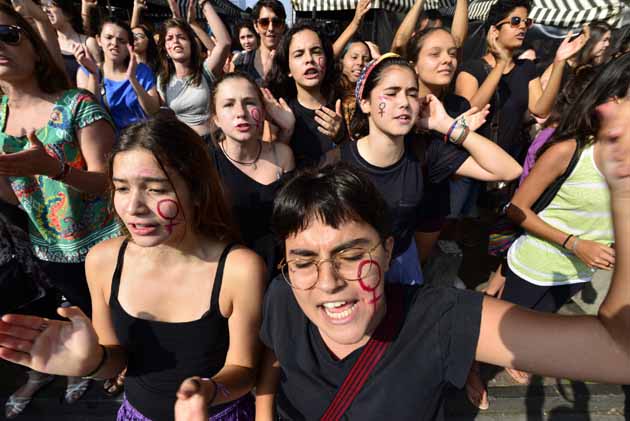 Women take part in a march in Sao Paulo on October 23, 2016, to protest against violence against women and in solidarity for the brutal killing of a 16-year-old girl in Mar del Plata The killing, in which the high school student was allegedly raped and impaled on a spike by drug dealers, is just the latest incident of horrific gender violence in Argentina, which has seen more than a year of mass marches to protest brutality against women. (Photo by Cris Faga/NurPhoto via Getty Images)