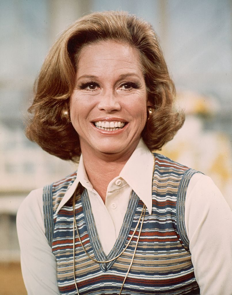circa 1977: American actor Mary Tyler Moore smiling in a headshot still from the television series, 'The Mary Tyler Moore Show'. She is wearing a white blouse with a striped knit vest. (Photo by CBS Photo Archive/Getty Images)