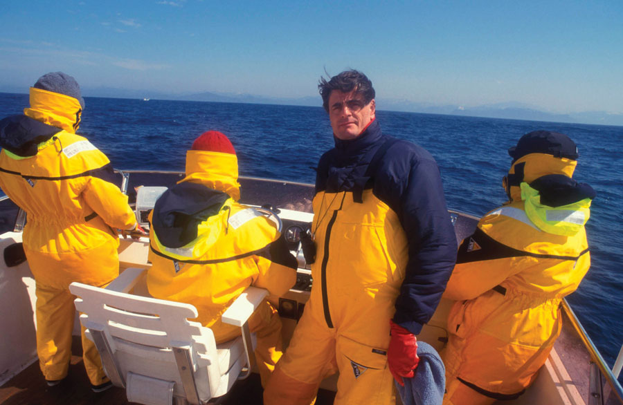 Allan Thorton and his team clad in yellow windbreakers on a boat off the coast of Japan. 