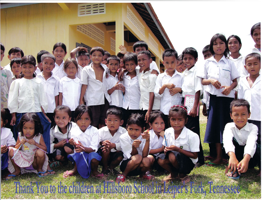 A thank-you card from the students in Cambodia to the kids in Tennessee who helped raise funds. The card features several of the students wearing white dress shirts. Thank you to the children at Hillsboro School in Leiper's Fork, Tennessee is written across the bottom. 