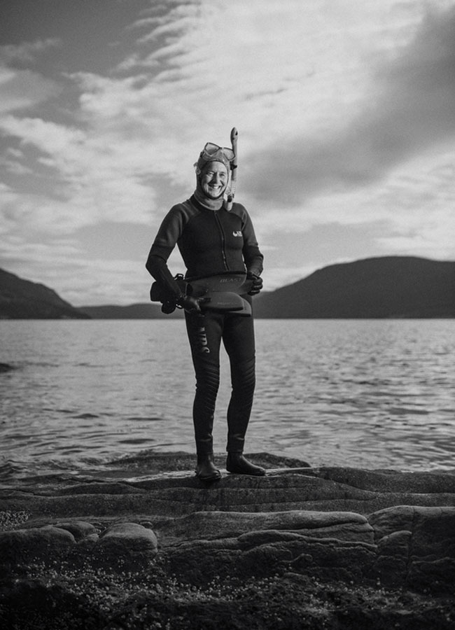 Jane Armstrong standing on the rocky shore of Salt Spring in British Columbia. 