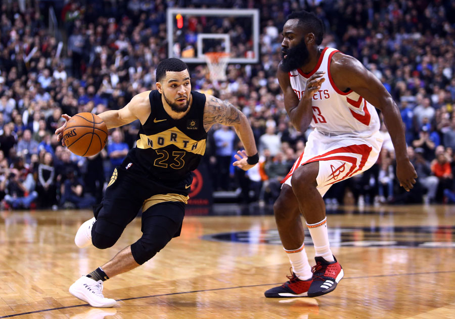 Fred VanVleet of the Toronto Raptors dribbles the ball as James Harden of the Houston Rockets defends.