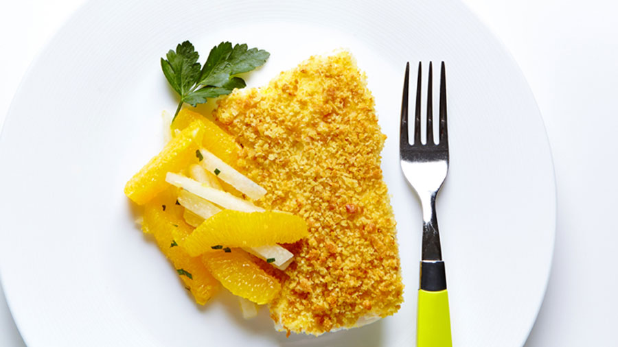 Baked Lemon Cod with Orange Jicama Salad beside a fork with a neon yellow handle on top of a white plate. 