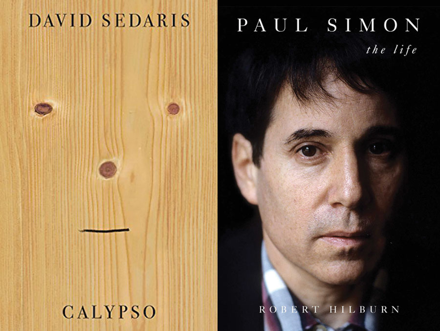 The cover for Paul Simon: The Life with a photo of a young Paul Simon and a second book cover for Calypso which features a photo of a piece of wood with scores in the formation of eyes, nose and a mouth added in black marker. 