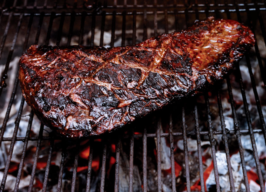 A slightly charred steak on the BBQ.