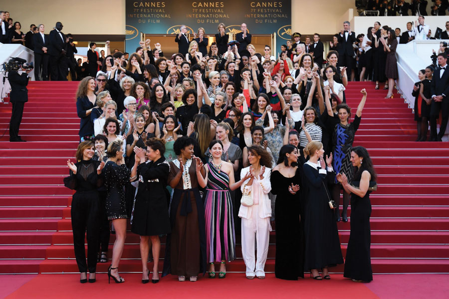 A diverse group of 82 actresses stand on the steps of the Palais des Festivals to signify the challenges women face in the industry.