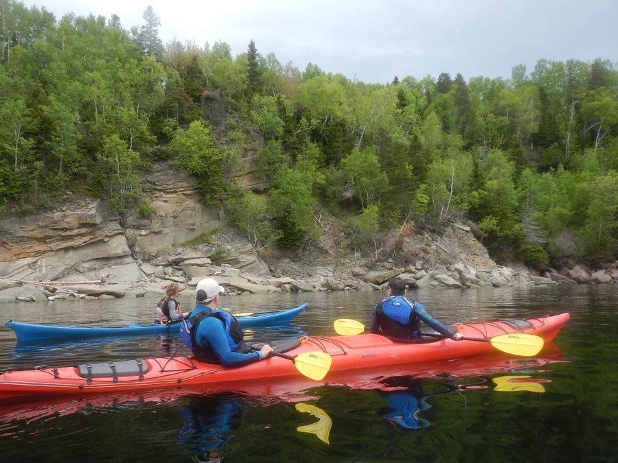 Sea kayaking along the shoreline of Gaspe Bay with Cap Aventure outfitters.
