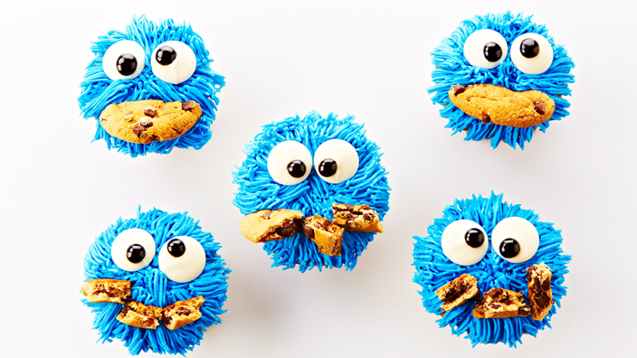 Blue cookie monster cupcakes with googly eyes and a cookie chunk for a mouth. 