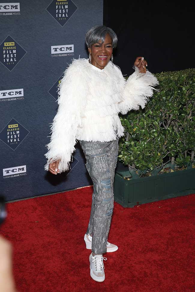 Cicely Tyson strikes a pose with a shimmery white feather coat and dark silver slacks. 