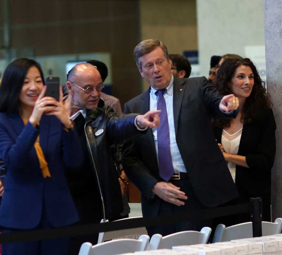 Mayor John Tory and Moses Znaimer pointing excitedly in the same direction. 
