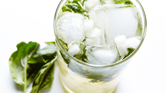An asian pear mojito in a glass with ice and mint leaves. 