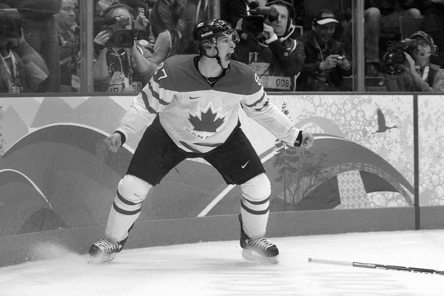 Sidney Crosby screams with his fists clenched as he celebrates the game winning goal at the 2010 Olympics.