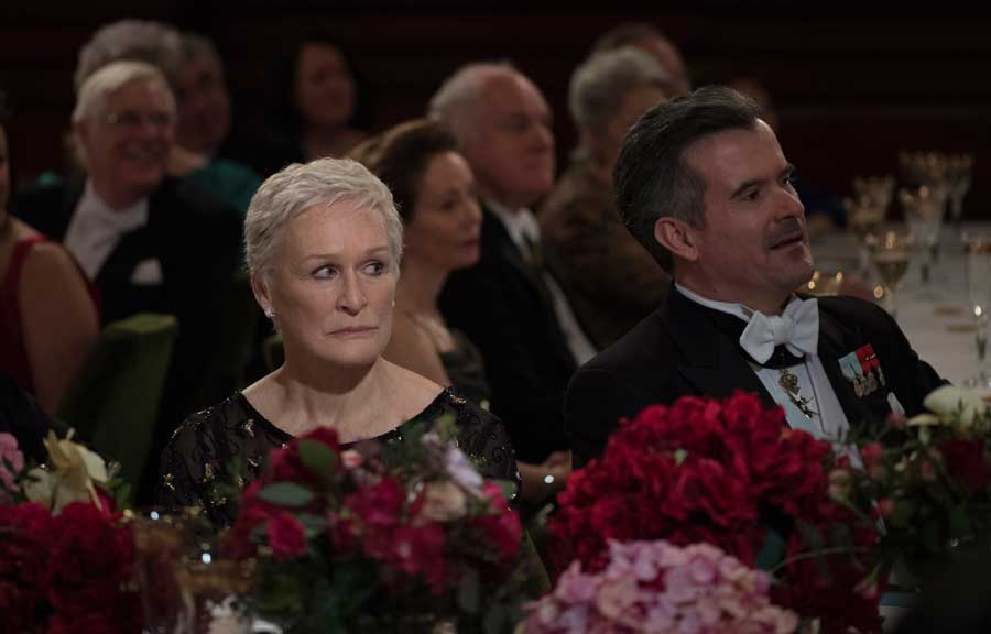 Glenn Close in The Wife listens as her onscreen husband accepts an award. 
