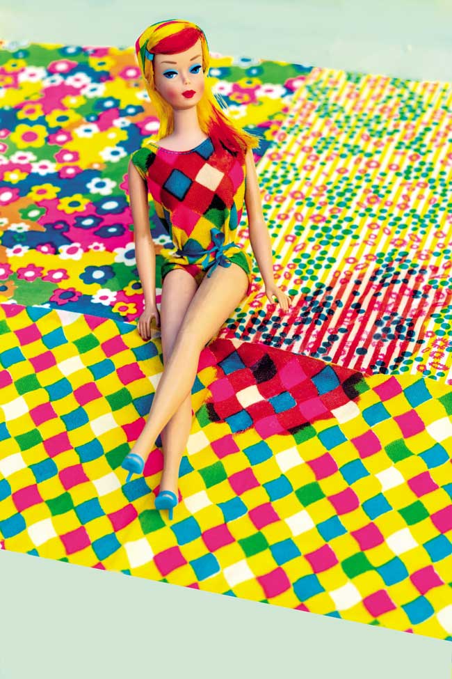 A barbie doll in a colourful bathing suit. 