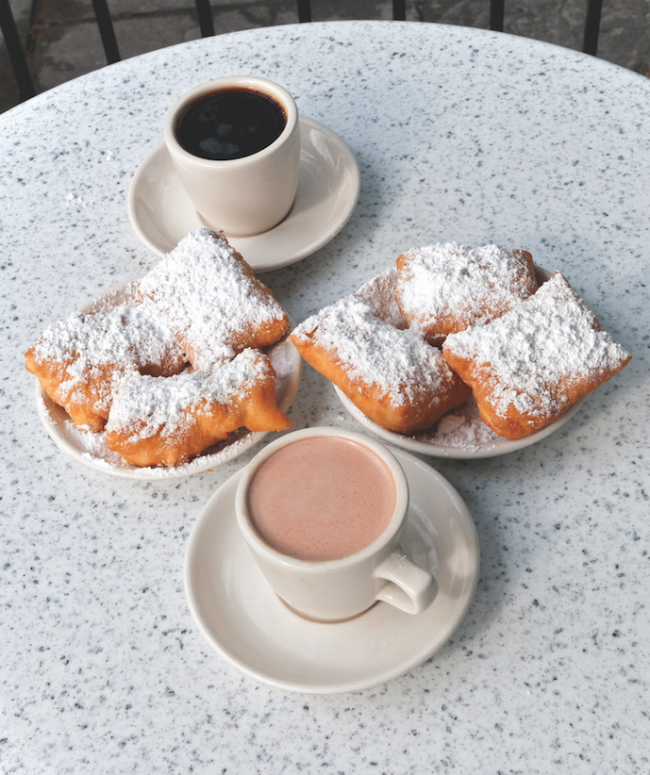 A photo of Beignets and Coffee on a table at Cafe du Monde.