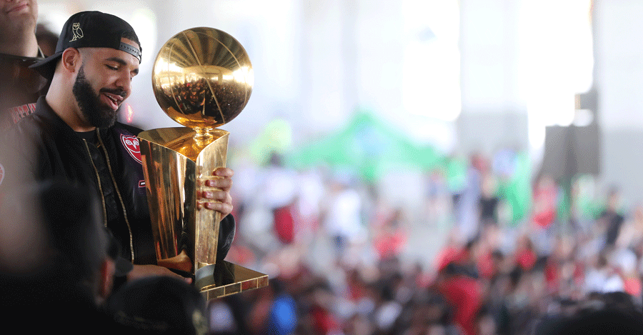 Drake holds the Larry O'Brien NBA Championship Trophy as the Toronto Raptors hold their victory parade.