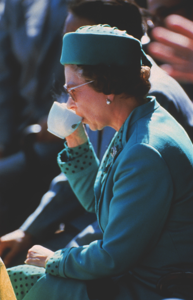 A picture of Her Majesty drinking a cup of tea in London, 1985. 