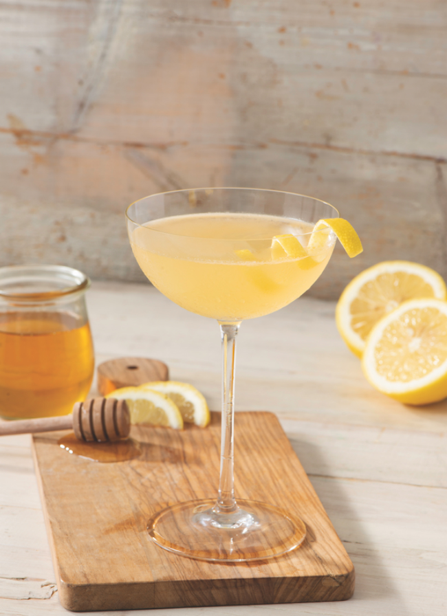 A Ungava Bee's Knees cocktail garnished with a twist of lemon.