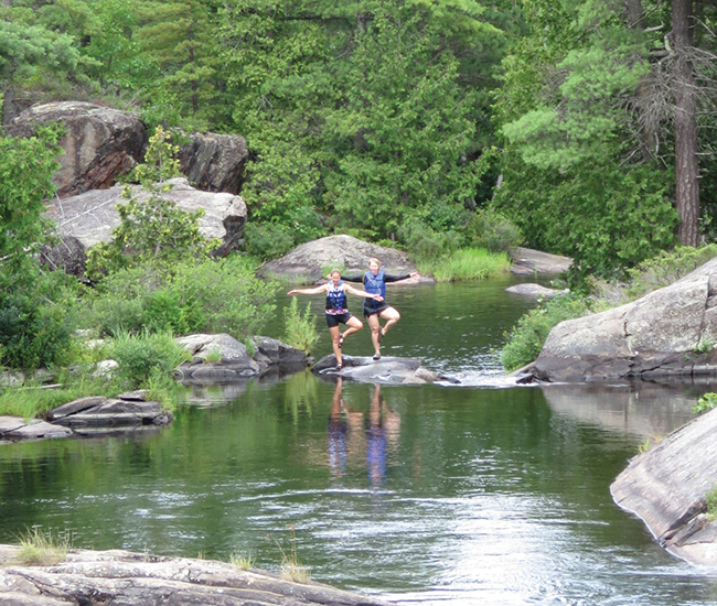 A photo of Coccimiglio and Yarmoluk holding the Tree pose at High Falls.