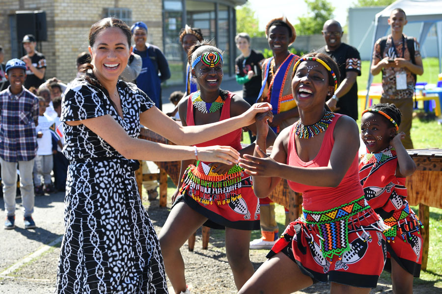 Meghan, Duchess of Sussex dances as she visits a Justice Desk initiative in Nyanga township, with Prince Harry, Duke of Sussex, during their royal tour of South Africa on September 23, 2019 in Cape Town, South Africa.