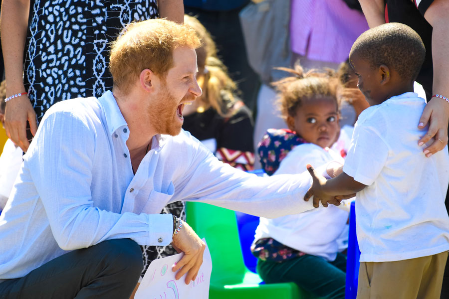 Prince Harry meets one of the children attending the Justice Desk initiative event in Nyanga township in Cape Town, South Africa.