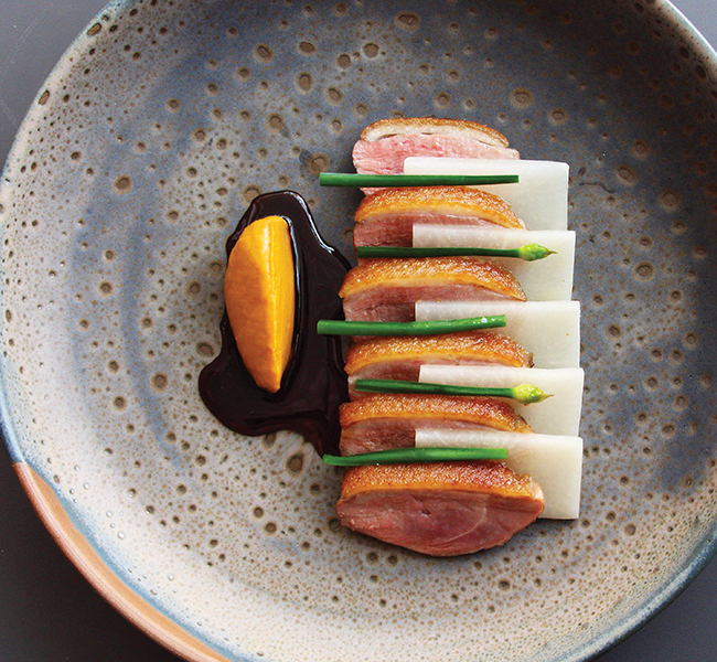 A photo of Dry Aged duck breast with fermented coffee jus and pickled turnip from Est. 
