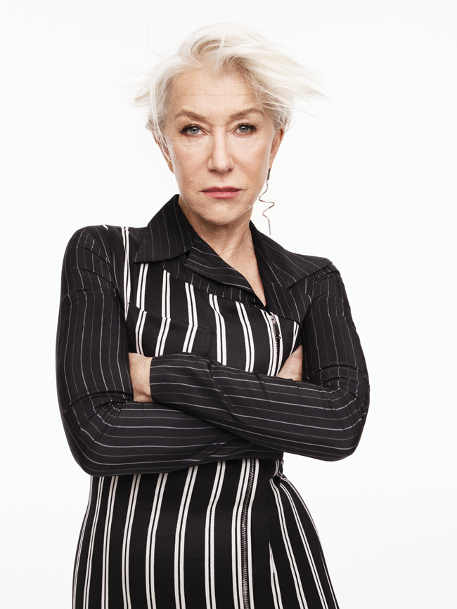 A photo of Helen Mirren in black and white striped top with arms crossed.