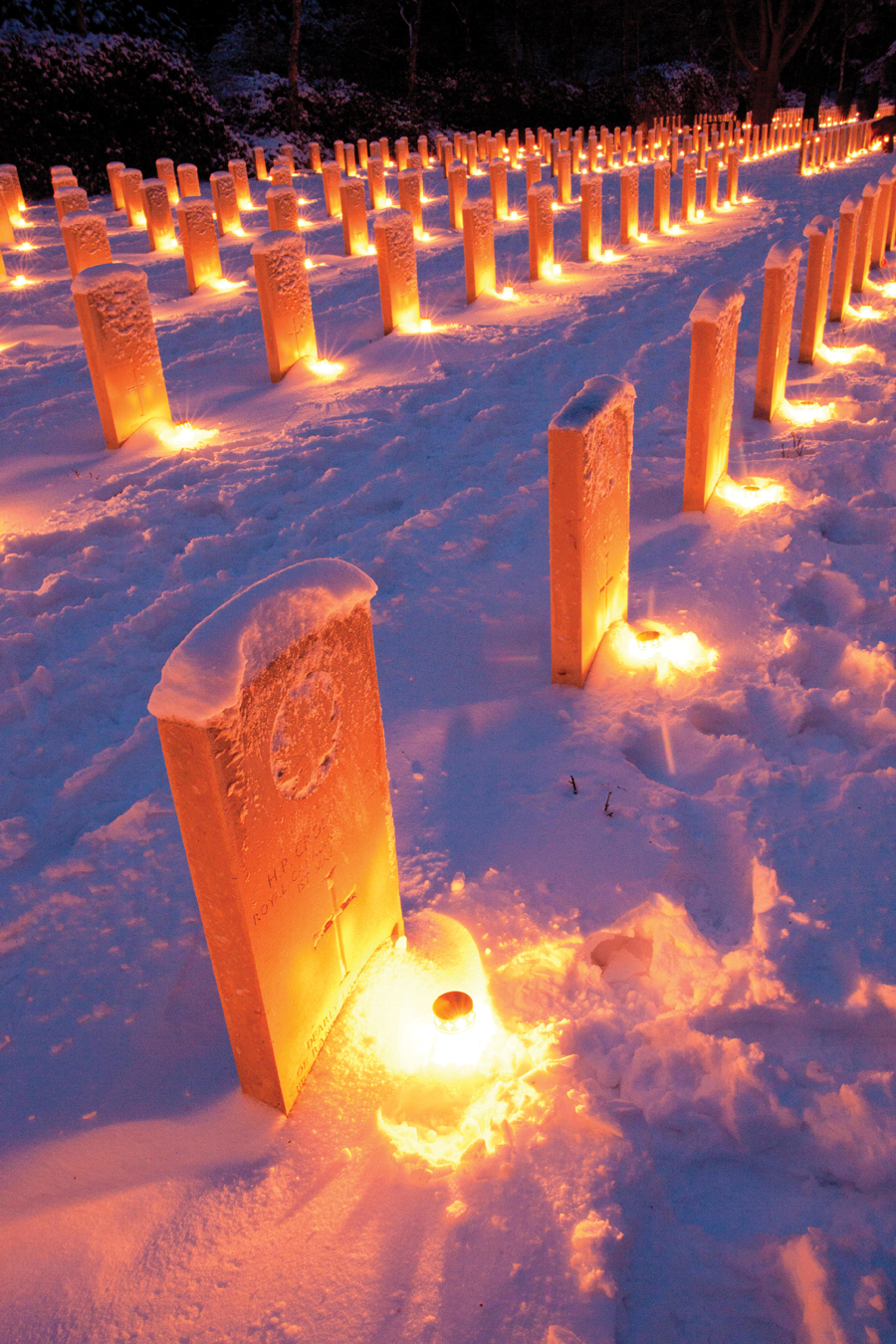 Candles lit at the headstones in the Canadian cemetery in Holten.