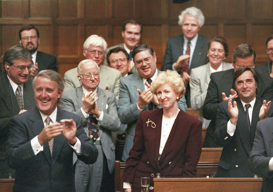 Kim Campbell, Leader of the Conservative Party and Prime Minister designate is given a standing ovation in the House of Commons by Prime Minister Brian Mulroney and other members of the government on June 16, 1993.