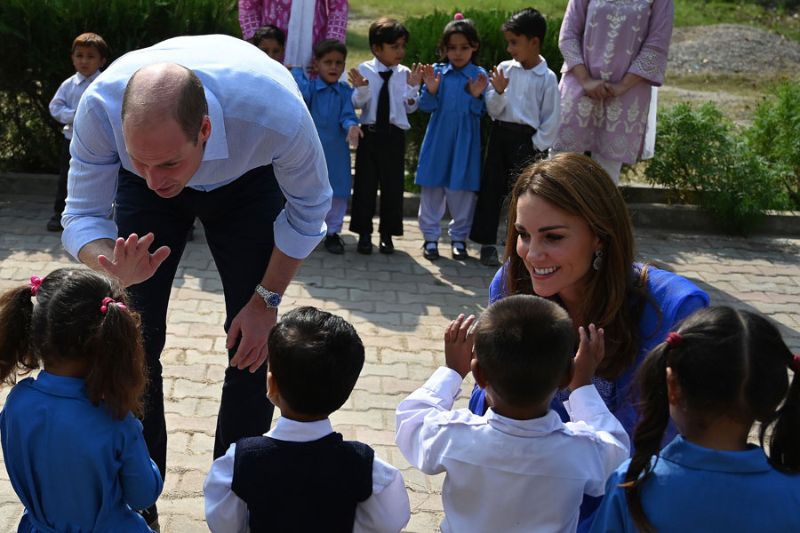 Britain's Prince William, Duke of Cambridge, and Catherine, Duchess of Cambridge, meet with school children during their visit to a government-run school in Islamabad, Pakistan.