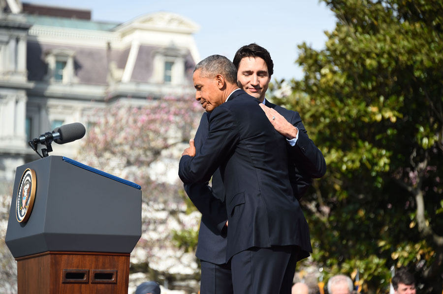 US President Barack Obama and Canada's Prime Minister Justin Trudeau hug during a welcome ceremony during a State Visit on the South Lawn of the White House. Photo: Jim Watson/AFP/Getty Images)