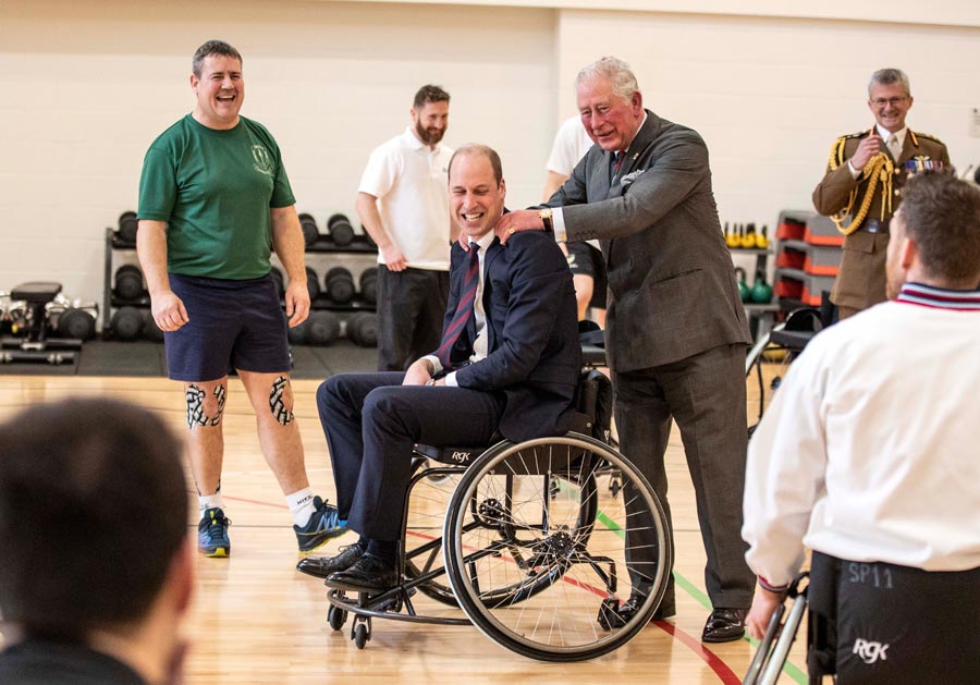 Prince William, Duke of Cambridge has his shoulders rubbed by Prince Charles, Prince of Wales after the Duke attempted and failed to throw a basket ball into the hoop, during a visit to the defence medical rehabilitation centre (DMRC) Stanford Hall on February 11, 2020 in Loughborough, United Kingdom. Photo: Richard Pohle/WPA Pool/Getty Images