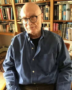 Portrait of author Clive Irving in his study.